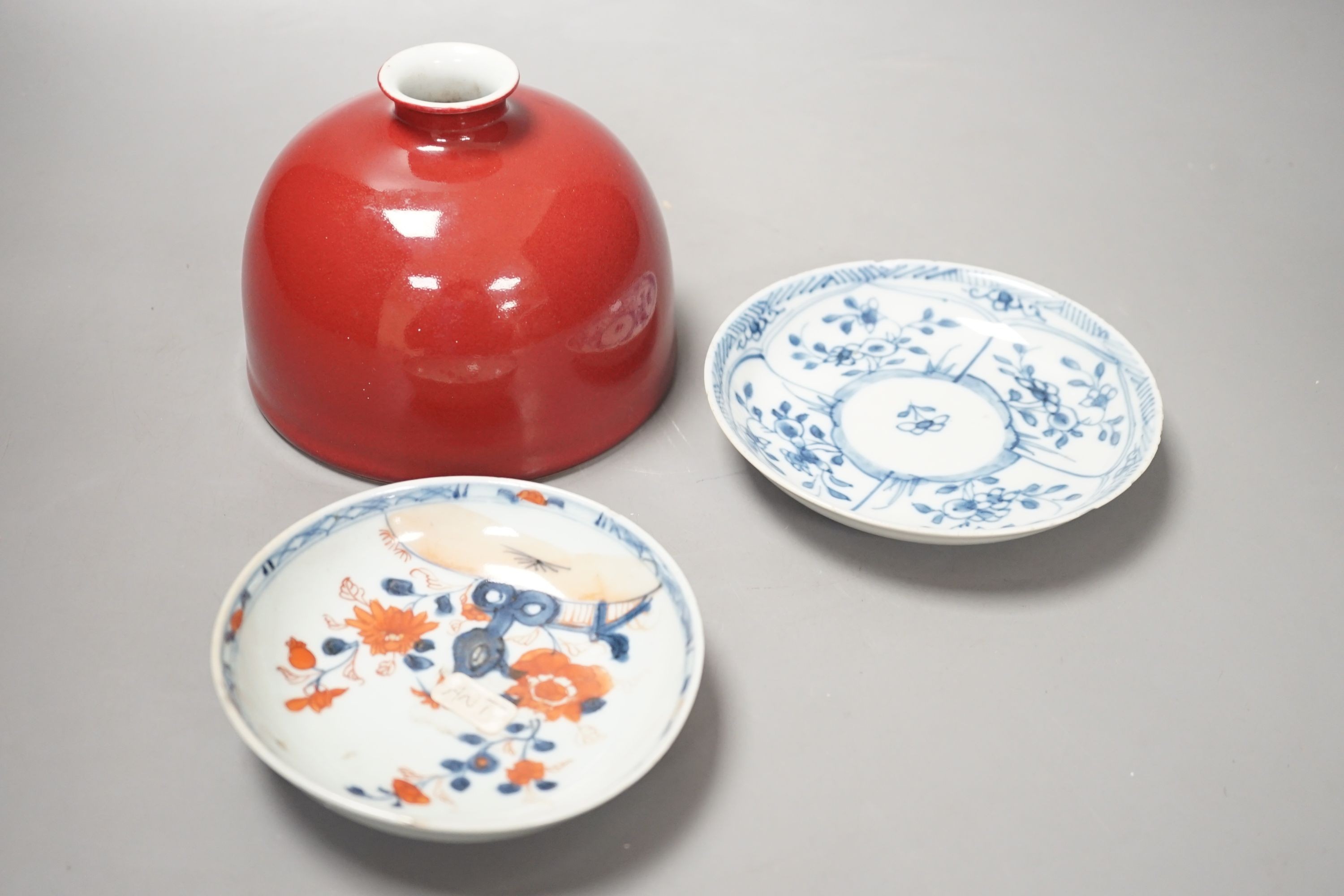 An 18th century Chinese Imari saucer, another blue and white saucer and sang de boeuf brush washer. Tallest 10cm